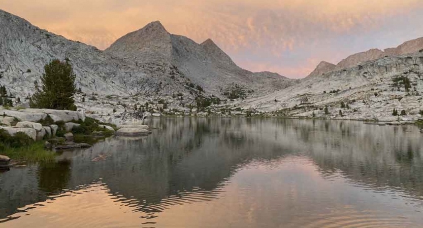 mountains are reflected in a body of water in the sierra nevada range